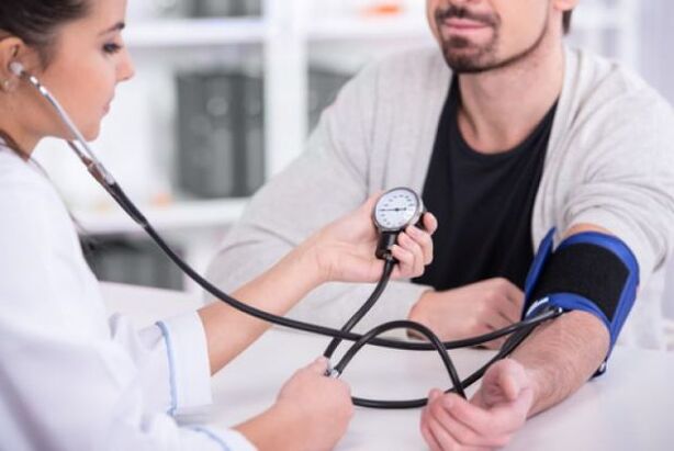 Doctor measuring blood pressure in hypertension